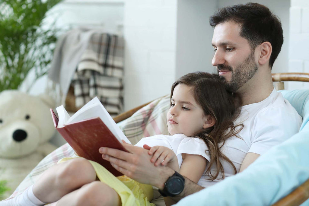 a dad reading some parenting quotes with her daughter