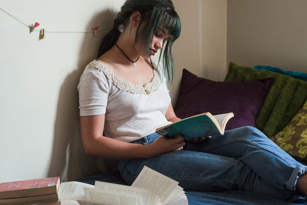 a girl reading books on childhood trauma