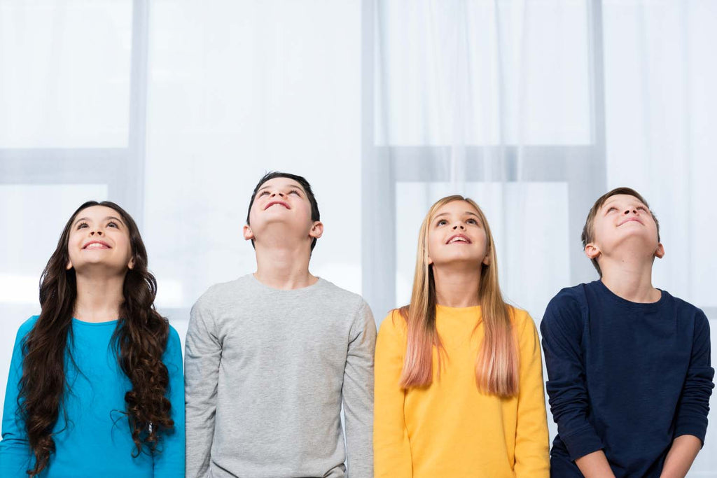 a group of elementary students doing deep breaths