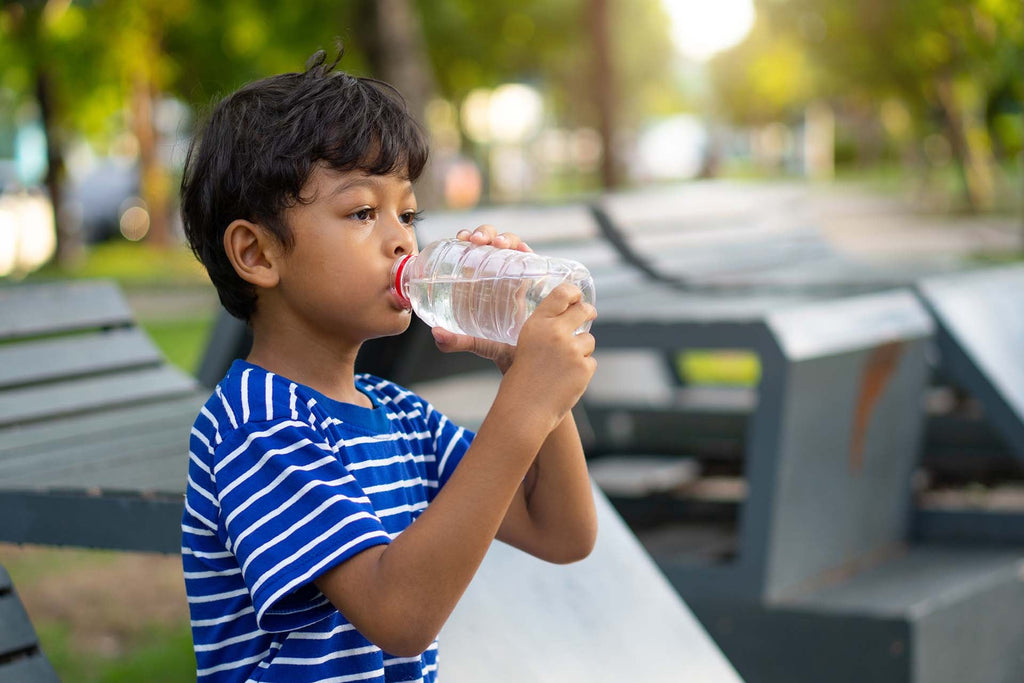 a kid drinking water