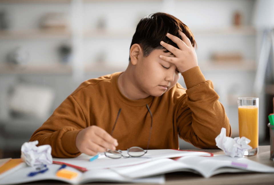 a kid experiencing mental paralysis while doing a homework