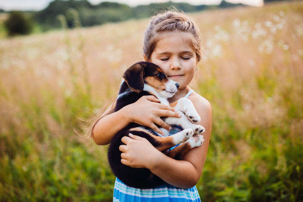 a little girl holding her pet