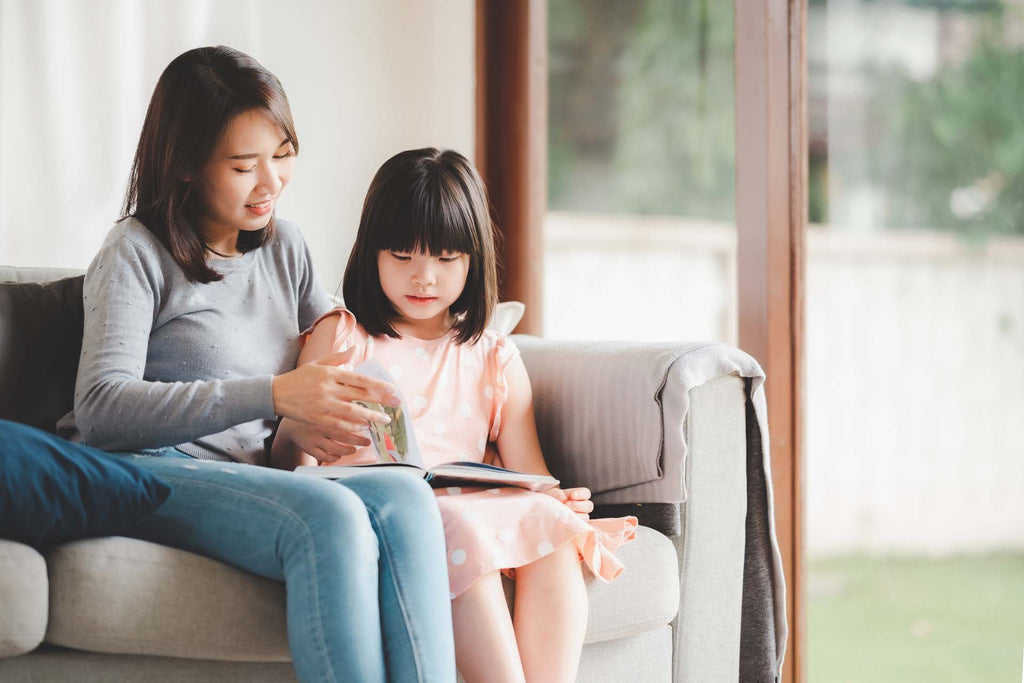 a mom and daughter reading a book about self-control