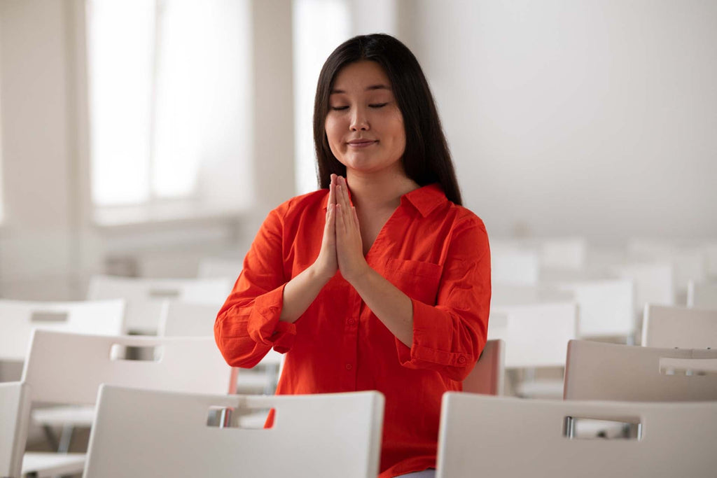 a teacher practicing self-care in a form of deep breathing
