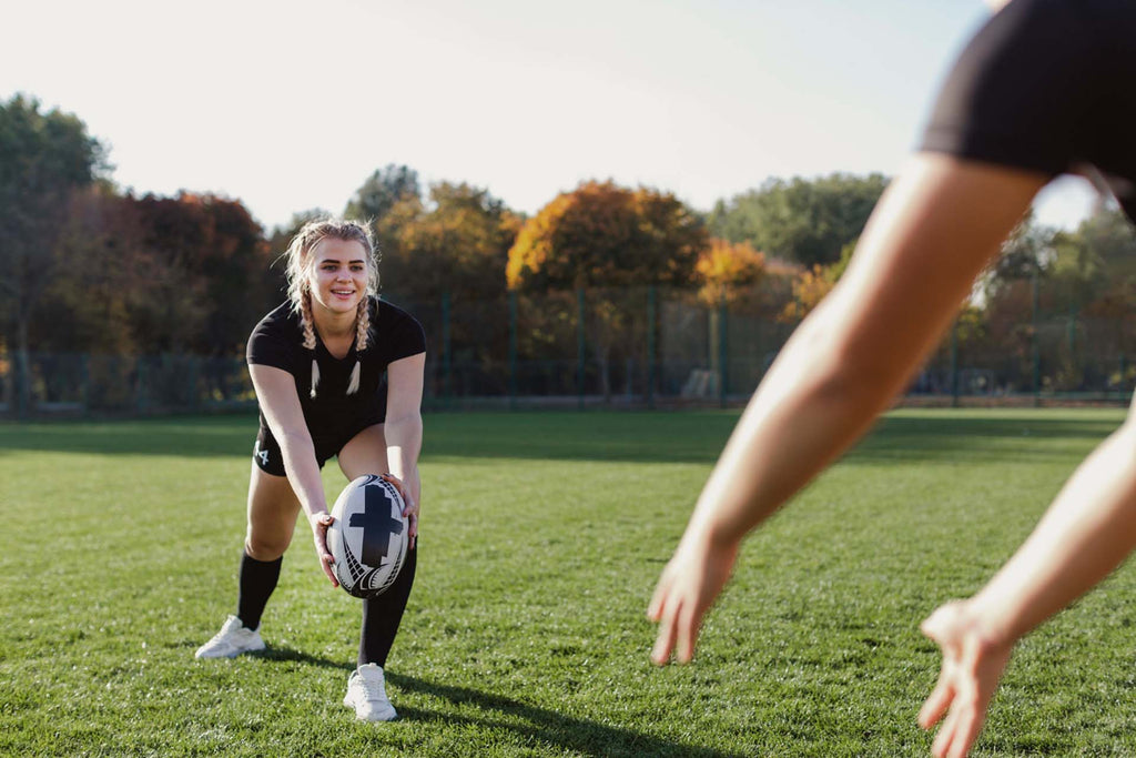 a teen throwing a rugby ball