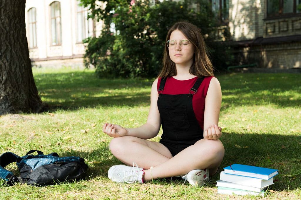 a teenage girl doing box breathing before studying