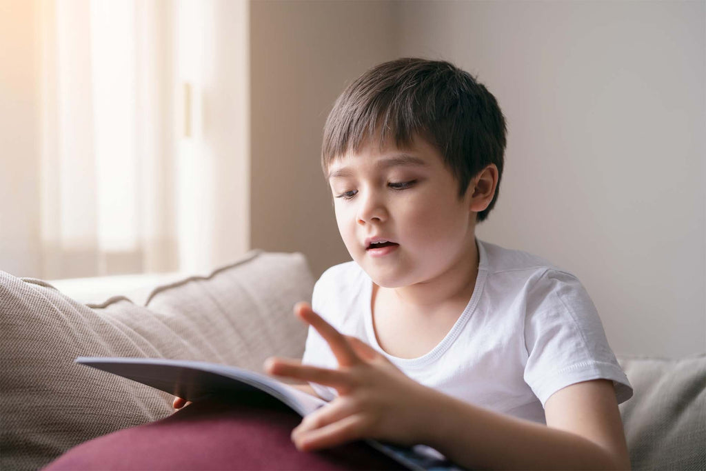 neurodiverse child reading a book