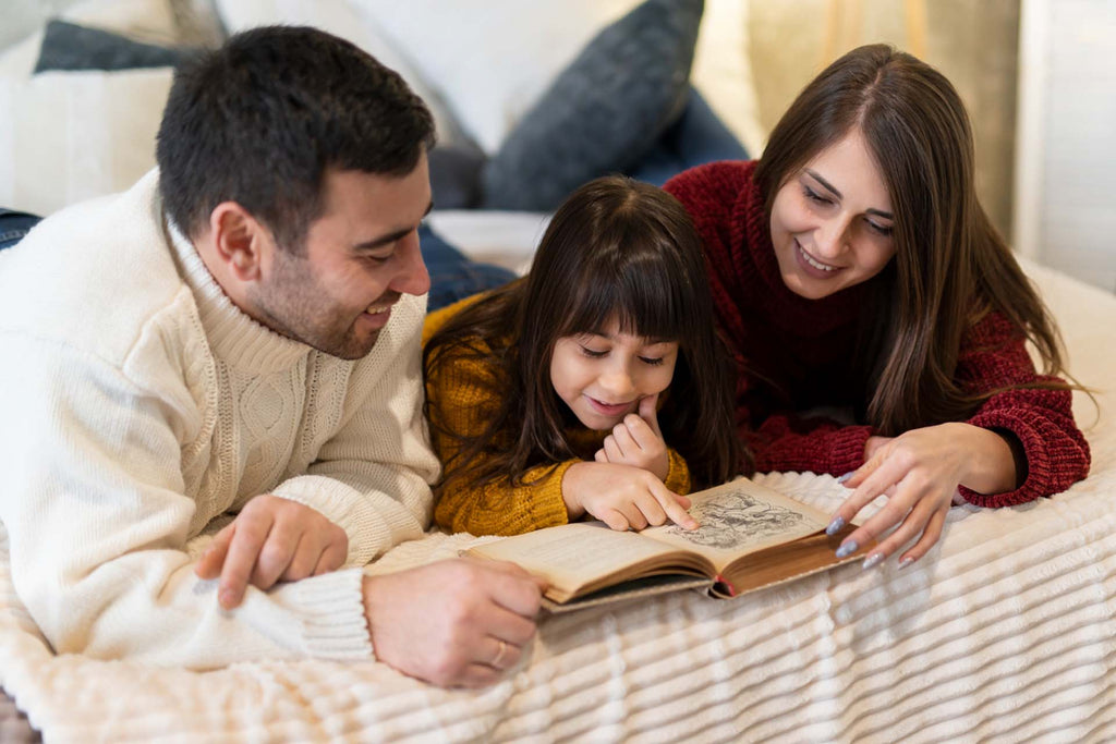 parents reading a book to their child who has autism